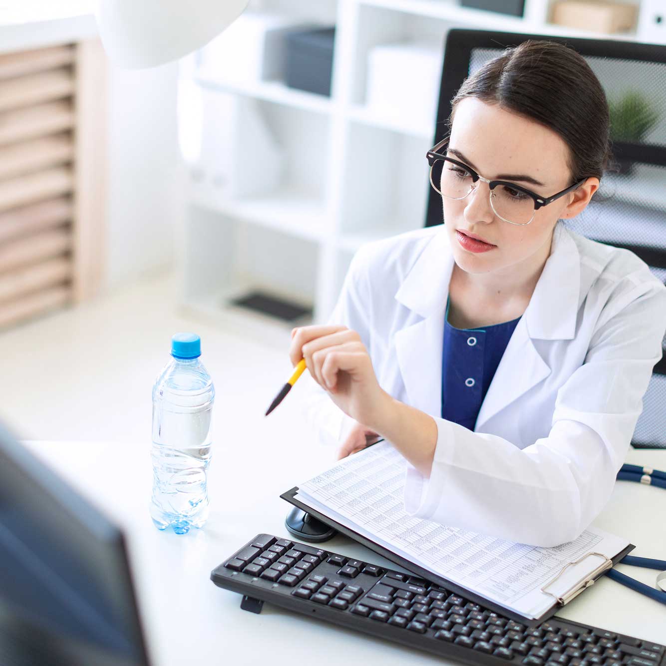 Female Doctor looking at computer
